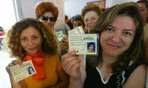 Lebanese women hold their election identity cards as they wait at a polling station. By Jamal Saidi/REUTERS