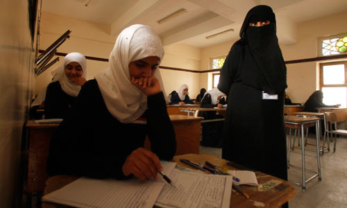 A teacher invigilates students in a classroom on the first day of the General Secondary Examinations in Sanaa. By Suhaib Salem/REUTERS